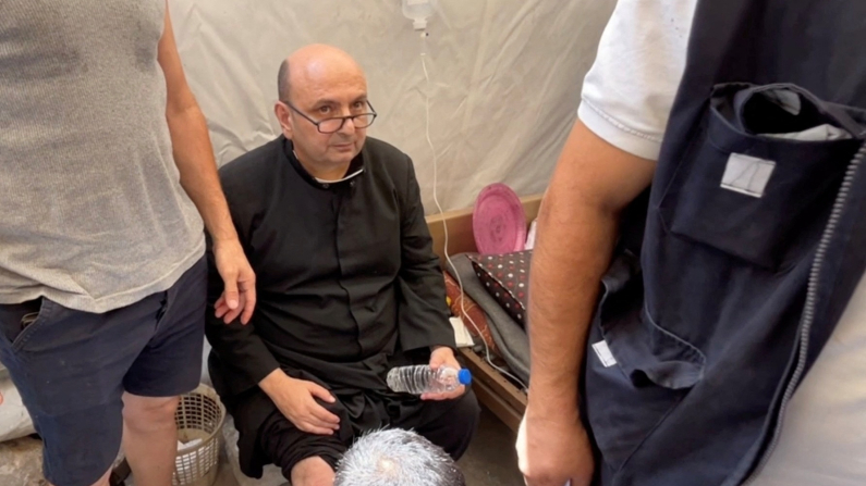 Don Gabriele Romanelli, parroco della Chiesa della Sacra Famiglia, riceve assistenza medica presso l'ospedale arabo Al-Ahli di Gaza City, dopo aver riportato lievi ferite alle gambe (immagine REUTERS/Dawoud Abu Alkas).